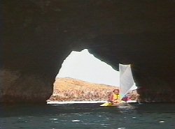 Sailing through a cave, steep Island