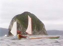 Laurie passing Big Caroline Rock, Port Davey